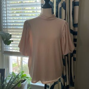 Velvet high neck blouse with puffed sleeves.